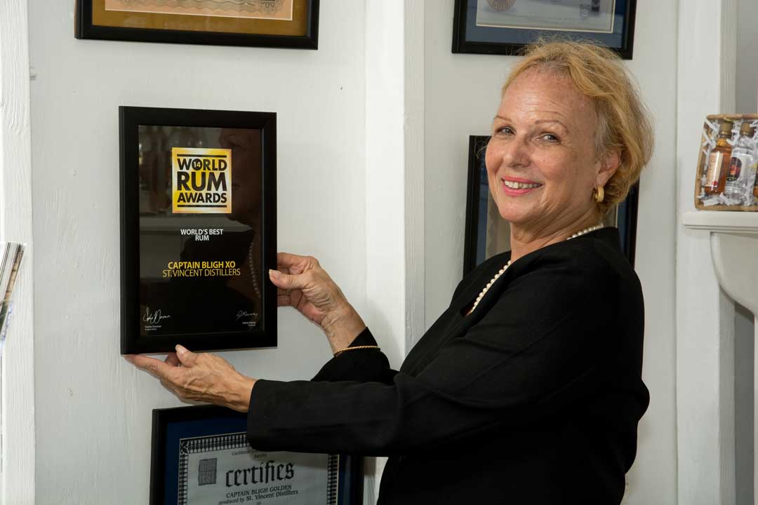 St Vincent Distillers team receiving an award at a rum competition ceremony with trophies and smiles